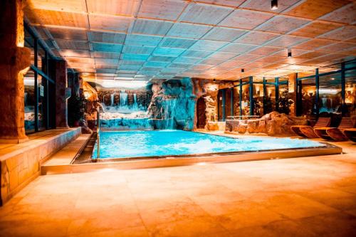 a large pool in a building with a large room at Spa Camping Schwarzwälder Hof in Seelbach