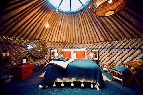 a bedroom with a bed in a yurt at Wester Auchraw Croft B&B in Lochearnhead
