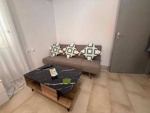 a living room with a couch and a coffee table at Sea Opera A4 in Kamena Vourla