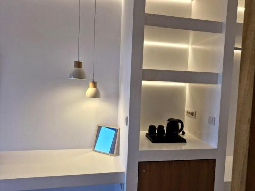 a room with a cabinet with a laptop in it at Villa Maniati Chrissi Ammos in Agios Petros