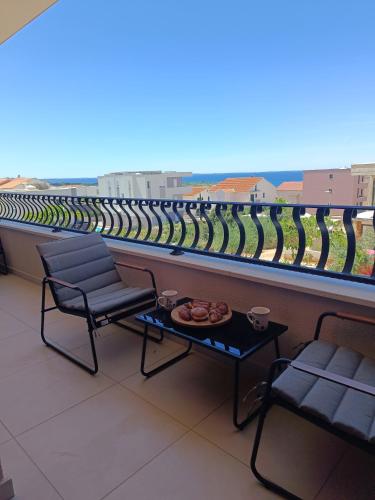 a balcony with two chairs and a table and a view at PaCha Boutique house in Novalja
