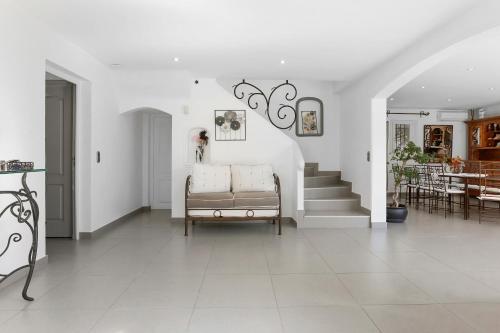 a living room with a couch and a staircase at Villa avec piscine au soleil d'Azur in Fréjus