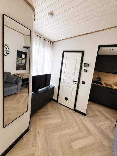 a living room with a door and a mirror at Pärnu Summer Studio in Pärnu