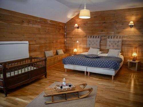 a bedroom with a bed and a table in it at Clos De La Gourmandière, Maison d'hôtes & Restaurant in Saint-Lothain