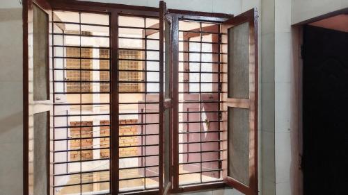 an open window with a view of a building at G R MANSION in Vellore