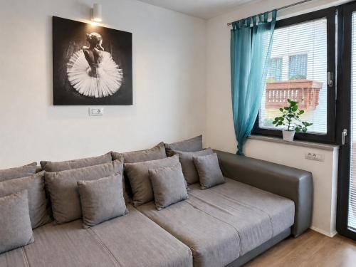 a couch in a living room with a window at Apartma Lilly in Bohinjska Bela