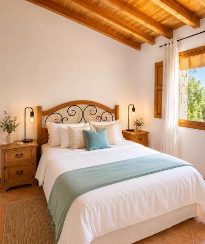 a bedroom with a large bed and a window at LA CUMBRE-Calma, Desconexión y Piscinas Naturales en Sierra de Gata TR-CC-00490 in Gata