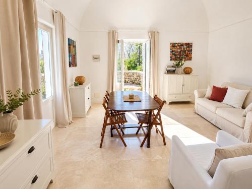 a living room with a table and a couch at Maridea - Villa Alta Marea in Ponza