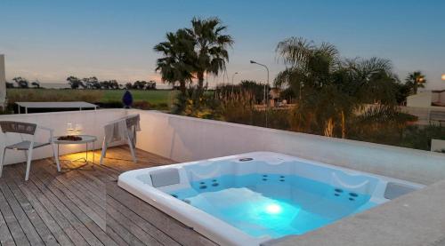 a hot tub sitting on top of a deck at Villa D'Argento in Ragusa
