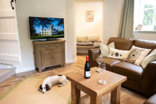 a living room with a dog laying on the floor at Grimsbury Castle in Thatcham