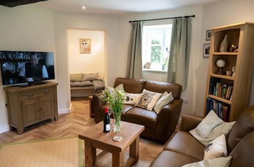 a living room with a couch and a table at Grimsbury Castle in Thatcham