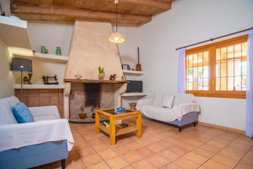a living room with a couch and a fireplace at Son Morro in Santa Margalida