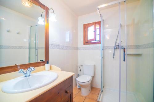 a bathroom with a toilet and a sink and a shower at Son Morro in Santa Margalida