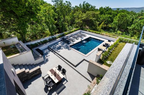 an overhead view of a swimming pool in a backyard at My Dalmatia - Sea View Villa Senti with private pool in Starigrad