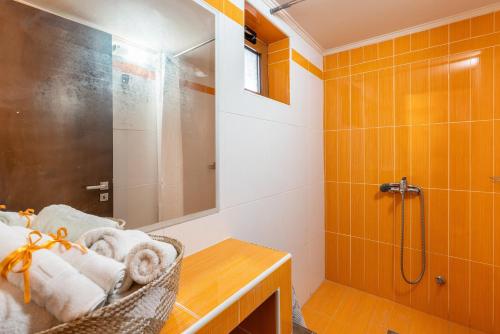 a bathroom with a shower and a basket of towels at Absinthia Legacy in Soroni
