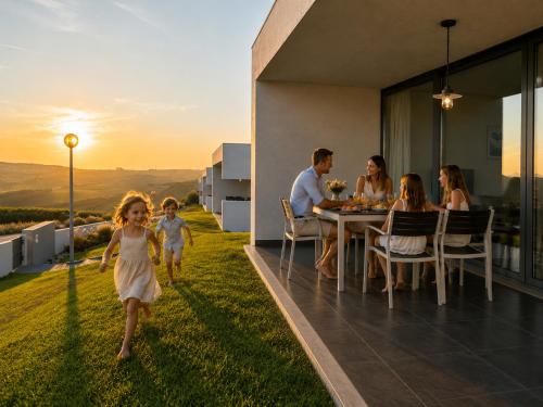 a group of people sitting around a table on a house at Carina Villas with Pool and Ocean view in Lourinhã