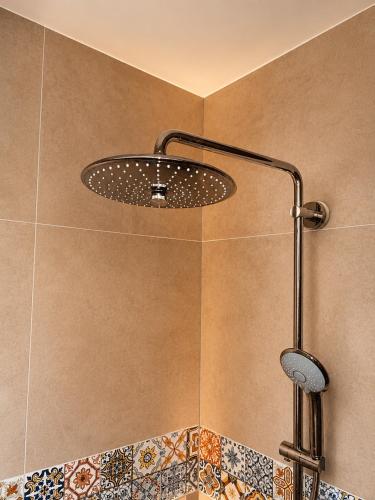 a shower with a shower head in a bathroom at Appartement "Hartje Haamstede" in Burgh Haamstede