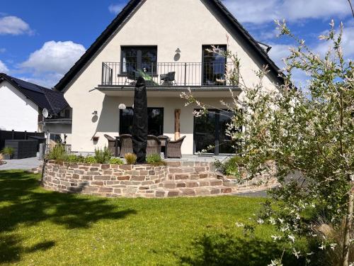 a white house with a black roof at Ferienhaus AhrIdylle in Bad Neuenahr-Ahrweiler