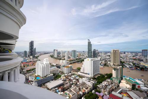 a view of a city with a river and buildings at State Tower Bangkok in Bangkok