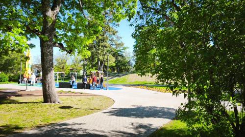a winding path in a park with a playground at Hostel Lõuna in Pärnu