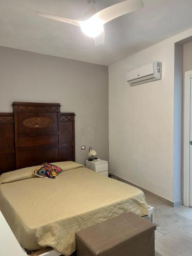 a bedroom with a bed and a ceiling fan at Dimora dei Climiti in Floridia