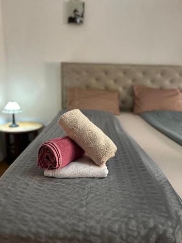 a pair of towels on a bed with at Apartman Stone Garden 2 in Mostar