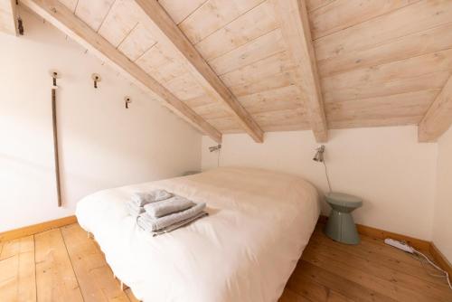 a bedroom with a bed in a room with wooden ceilings at Agriturismo Valleponci in Finale Ligure