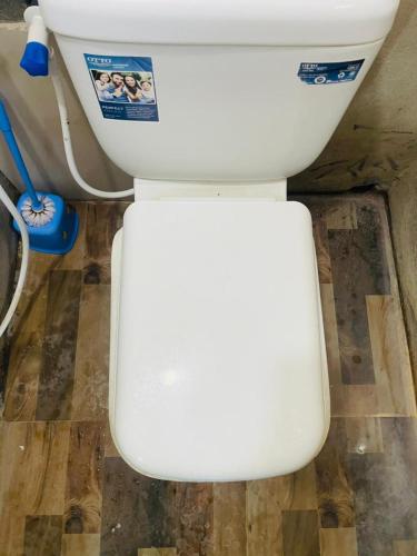 a close up of a white toilet in a bathroom at Blue Heaven in Mannar