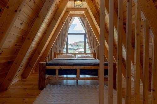 a bedroom with a bed in a attic at Falcon View Zabljak in Žabljak