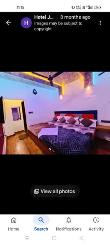 a screenshot of a hotel room with two beds at Hotel shree jagannath palace in Ujjain