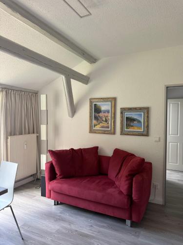 a red couch sitting in a living room at Brauhaus Suite 20 in Sebnitz