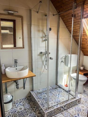 a bathroom with a shower and a sink at Zöldház Panzió in Gyenesdiás