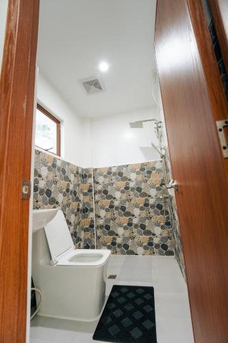 a small bathroom with a toilet and a sink at Casa Lucia Resort Hotel in Oslob