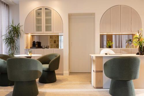 a waiting room with chairs and a counter at Hotel La Tonkine ex Olympia in Beausoleil