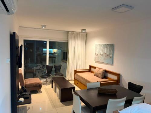 a living room with a couch and a table at Green Park in Punta del Este