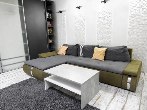 a living room with a couch and a coffee table at Ady Házikó in Pécs