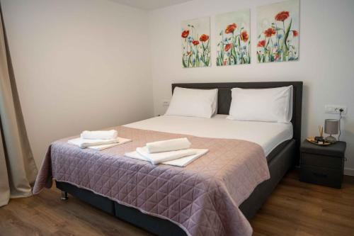 a bedroom with a bed with two towels on it at Casa Carlo in Sinj