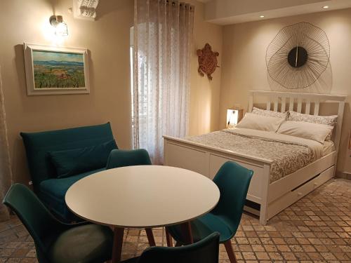 a bedroom with a bed and a table and chairs at MancioBiba Home in Trevi