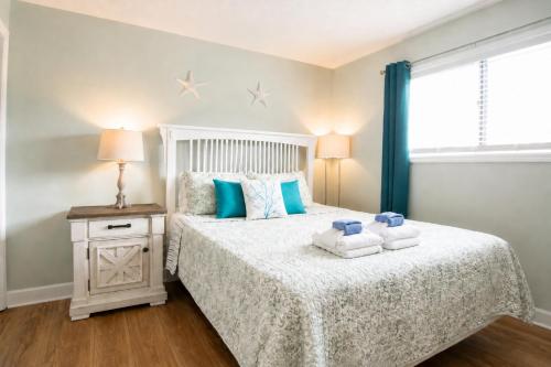 a bedroom with a bed with towels on it at Family Getaway - Boardwalk to the Beach, 3 pools, Tennis in Hilton Head Island