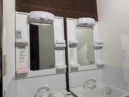a bathroom with three mirrors and two sinks at HANA88のa,b in Otsu