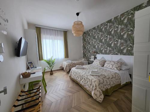 a bedroom with a bed and a couch and a tv at B&B La Rotonda in Frattamaggiore