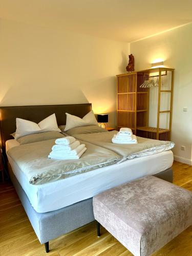 a large bed with two towels on it in a room at Elbsleep in Dömitz