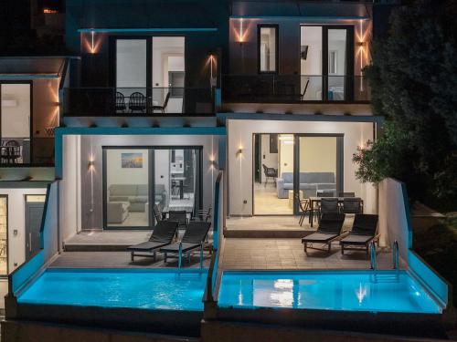 a house with a swimming pool at night at Villas Kaiafa “Ismini” in Polychrono