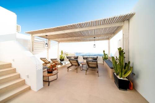 a patio with a table and chairs on a building at Imera Vista Suites in Imerovigli