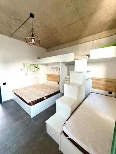 a bedroom with two beds and a ceiling at Sunrise Panorama Terrace in Ozurgetʼi