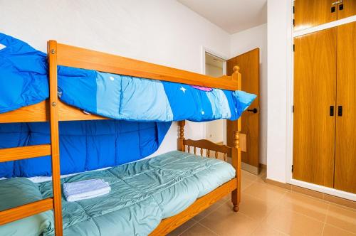 two bunk beds in a room with a door at Escondite Brisa Marina in Calpe