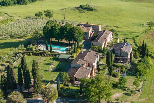 an aerial view of a house with a swimming pool at Borgo Tignano in Casole dʼElsa