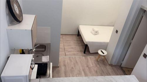 a small room with a bed and a table at European District Hostel in Brussels
