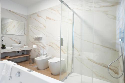 a bathroom with a toilet and a glass shower at La Terrazza del benessere in Ferrazzano
