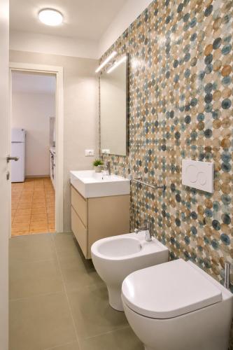 a bathroom with a toilet and a sink at Residence Columbia in Bibione